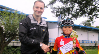 British Cycling NW Development Manager Alex Scoular presenting Tosh with his award