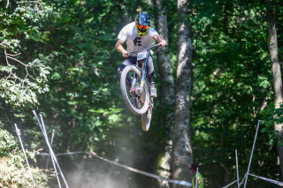 National Downhill series round 4, rider shot mid air on track in Caersws, Wales.