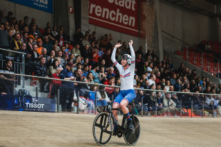 Katie Archibald celebrates on bike