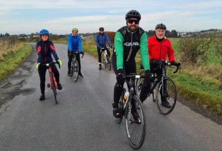Group of cyclists, male and female, led by a Guided Rides leader