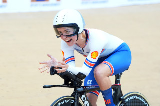 Daphne Schrager celebrating on bike