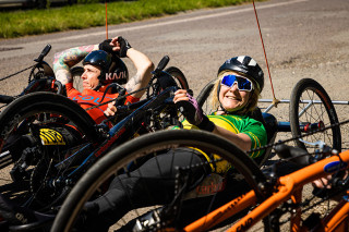 Two riders on hand cycles