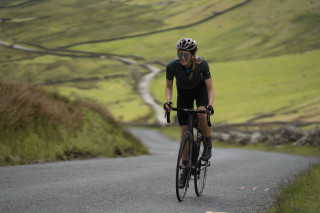 A rider out of the saddle at the top of the infamous Struggle climb in Cumbria