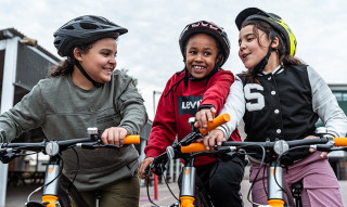 3 girls laughing with brand new Trek bikes