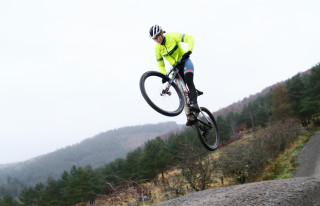 Ella McLean-Howell jumping on her mountain bike