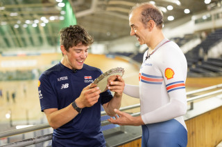 Archie Atkinson receiving his SportsAid second place award from teammate Will Bjergfelt