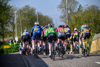 A group of riders racing up a hill