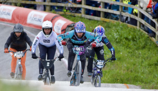 BMX riders pumping mid-race