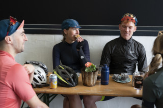 Riders at a cafe, stopping for drinks and snacks mid-ride