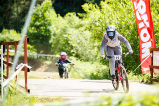 Two riders during round 4 of The 2024 Schwalbe British 4X Series at Afan Bike Park, Port Talbot, Wales, United Kingdom