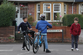 Children playing out on their street and cycling