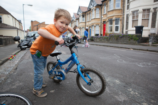 Children playing out on their street and cycling