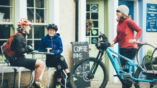 Riders at a cafe with eMTBs