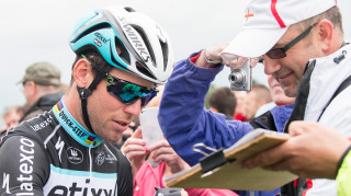 Mark Cavendish signs an autograph for a fan at the 2015 British Cycling National Road Championships in Lincoln.