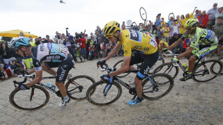 Chris Froome on the cobbles behind eventual stage winner Tony Martin.
