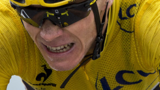 Chris Froome grimaces as he crosses the line to complete stage 19