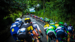 The peloton chase the breakaway on stage two