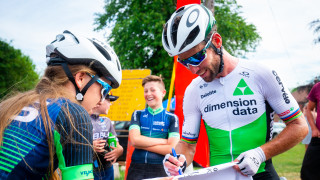Mark Cavendish signs something for a young fan at the British National Championships.