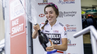 Sophie Wright sprays champagne on the podium as she leads the 2018 Women's Road Series.