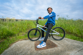 A child on a bike in a public park.