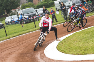 Speedway cyclists racing at speed