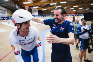Will Perrett celebrates winning omnium bronze with coach Ben Greenwood at the 2023 European track championships in Grenchen