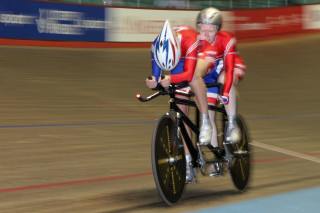 Visa Paralympic World Cup Scottish Paralympic Cyclist Aileen McGlynn on the back of the tandem with Ellen Hunter the pilot, both wearing the old "union flag" style GB kit and seem to be racing at Manchester Velodrome